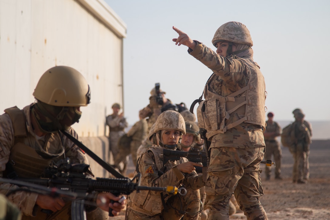 Jordan Armed Forces Warrant Officer Haneen Waqueez, Mohamed Bin Zayed Brigade/Quick Reaction Force Female Engagement Team, directs members of the FET where they are going to next during a coalition situational training exercise lane during Exercise Eager Lion 19, near Amman, Jordan on Sept. 3, 2019. The JAF FET were integrated into the JAF 81st Rapid Intervention Battalion alongside with the 3 Parachute Regiment, 3rd Battalion. (U.S. Army National Guard photo by Cpl. Elizabeth Scott)