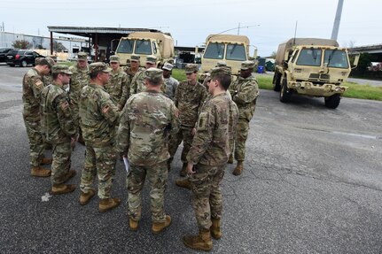 U.S. Army Staff Sgt. Draper Daniels (front-center of group), B Company, 1-118th Infantry Battalion from North Charleston, South Carolina, briefs the crews of four South Carolina National Guard Light Medium Tactical Vehicles (LMTV) assigned to the 1-118th Infantry Battalion of their assignments to local fire departments throughout the city of Charleston, South Carolina in preparation to assist local first responders with rescue calls caused by Hurricane Dorian, Sept. 4, 2019.