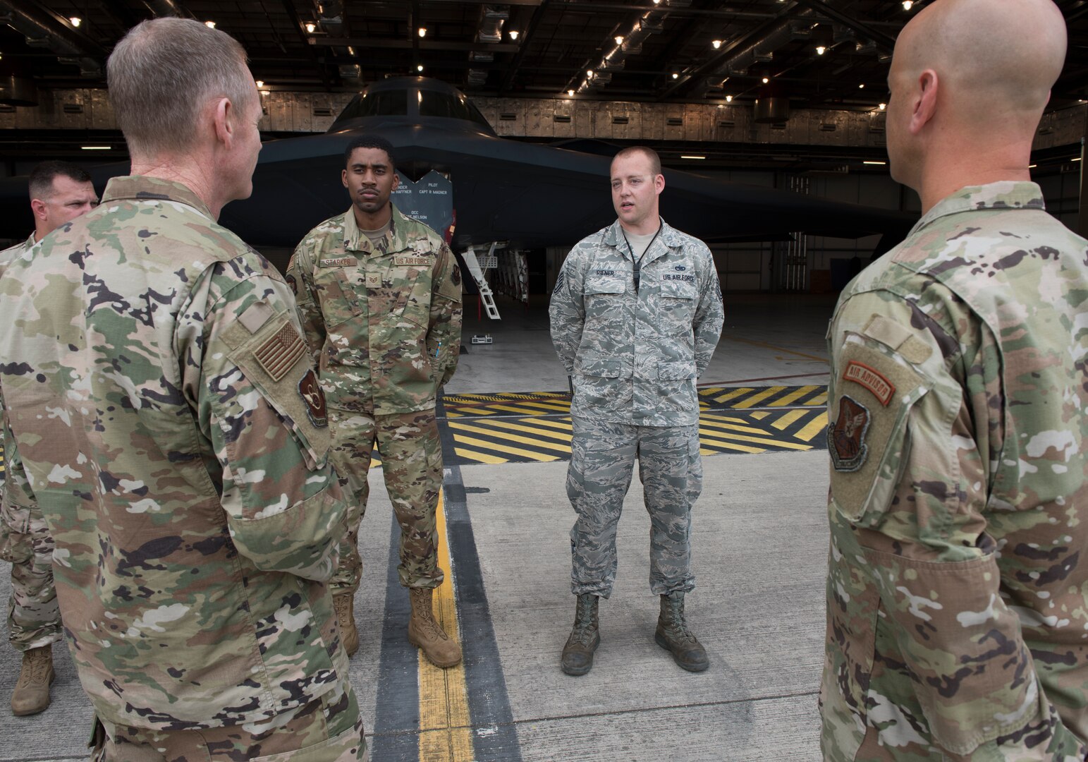 Technical Sergeant Erik Reiner, an aerospace ground equipment member assigned to the 509th Aircraft Maintenance Squadron at Whiteman Air Force Base, Missouri, talks to Major General James Dawkins Jr., the Eighth Air Force commander, on August 27, 2019, at Royal Air Force Base Fairford, England. Dawkins coined Reiner for his contributions to Team Whiteman's mission. Members of Team Whiteman, along with along strategic partners have deployed as part of a Bomber Task Force to the European Command area of operations to conduct theater integration and flying training. (U.S. Air Force photo by Staff Sgt. Kayla White)