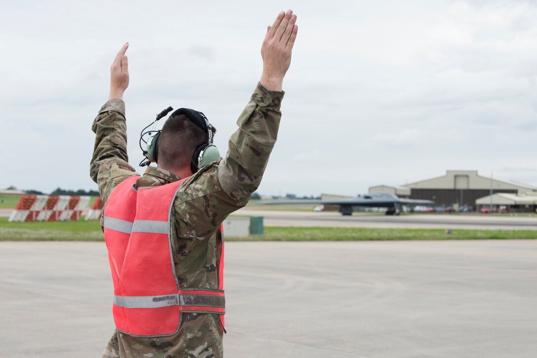 An Airman assigned to the 509th Bomb Wing marshals in Major General James Dawkins Jr., Eighth Air Force commander, as he taxis in a B-2 Spirit on the flight line of Royal Air Force Base Fairford, England, on August 28, 2019. Dawkins flew the stealth bomber during his visit to engage with members of Whiteman Air Force Base, Missouri, who had deployed to Royal Air Force Fairford as a Bomber Task Force to conduct theater integration and flying training. (U.S. Air Force photo by Staff Sgt. Kayla White)