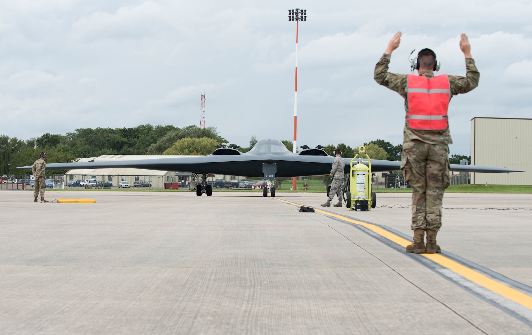 An Airman assigned to the 509th Bomb Wing marshals in Major General James Dawkins Jr., Eighth Air Force commander, as he taxis in a B-2 Spirit on the flight line of Royal Air Force Base Fairford, England, on August 28, 2019. Dawkins flew the stealth bomber during his visit to engage with members of Whiteman Air Force Base, Missouri, who had deployed to Royal Air Force Fairford as a Bomber Task Force to conduct theater integration and flying training. (U.S. Air Force photo by Staff Sgt. Kayla White)