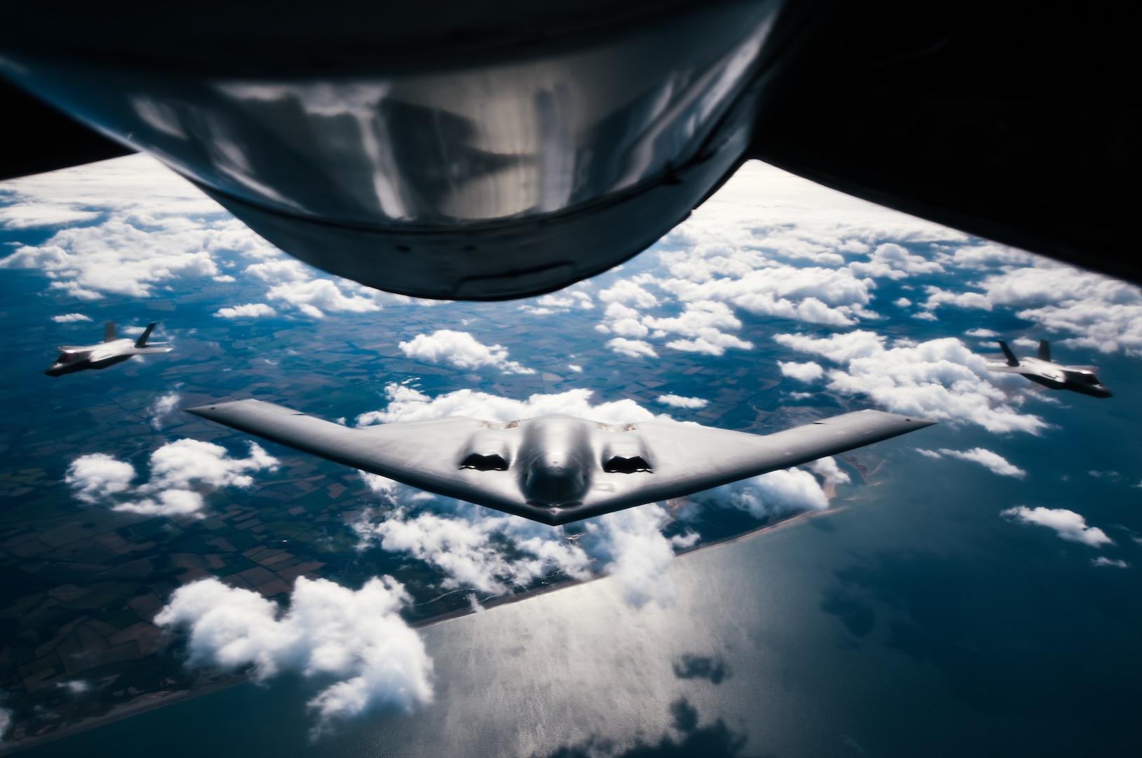 A U.S. Air Force 509th Bomb Wing B-2 Spirit is flanked by two United Kingdom Royal Air Force F-35 Lightning IIs during a Bomber Task Force training exercise over England, Aug. 29, 2019.