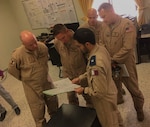 Members of the West Virginia Air National Guard's 130th and 167th Airlift Wing discuss current operations planning and procedures with representatives of the Qatari Emiri Air Force Aug. 17, 2019, at Al Udeid Air Base, Qatar.