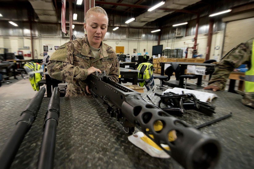 Sgt. Brittany Deturo, weapons quality assurance, 401st Army Field Support Battalion-Kuwait, disassembles a M2 .50-caliber machine gun in the weapons maintenance facility of Army Prepositioned Stocks-5, Aug. 17, Camp Arifjan, Kuwait. Deturo is a member of the 776 Support Maintenance Company of the Tennessee National Guard.