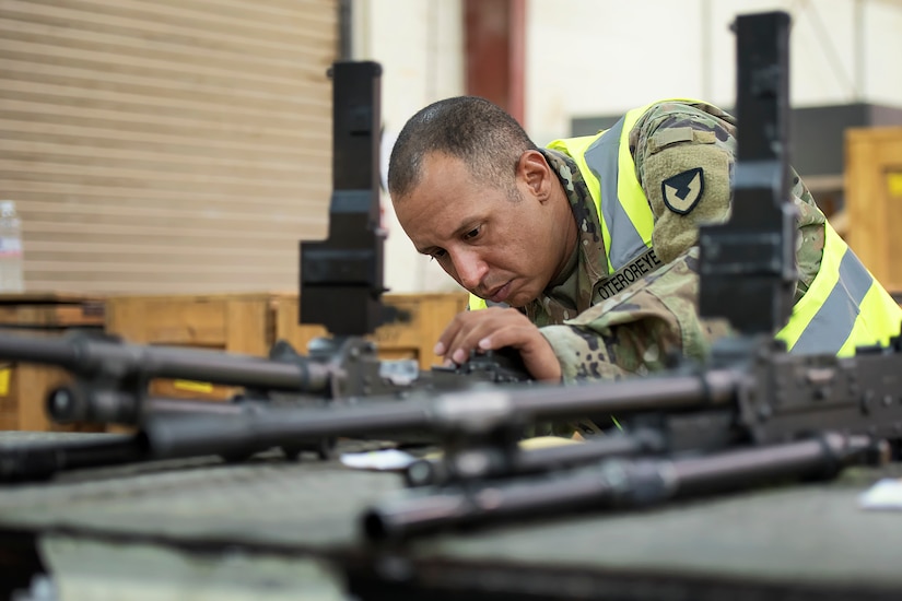 Staff Sgt. Samuel Oteroreyes, weapons quality assurance, 401st Army Field Support Battalion-Kuwait, inspects a line of M240C machine guns in the weapons maintenance facility of Army Prepositioned Stocks-5, Aug. 26, Camp Arifjan, Kuwait.