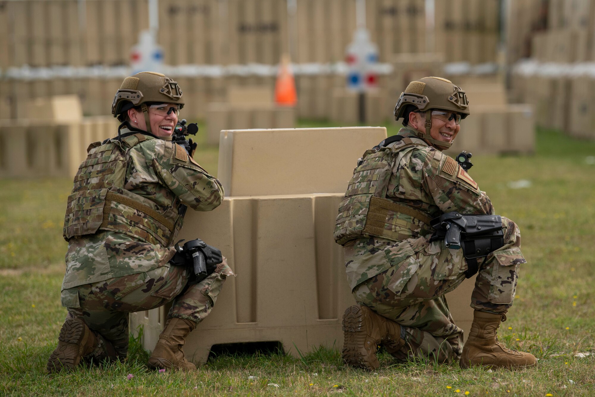 Chief Master Sgt. Kathi Glascock, left, 100th Air Refueling Wing command chief, and Col. Troy Pananon, 100th ARW commander, participate in shoot, move and communicate training with Airmen from the 100th Security Forces Squadron at RAF Mildenhall, England, Aug. 30, 2019. The purpose of the training was for the defenders to demonstrate their advanced combat skills for the commander and command Chief. (U.S. Air Force photo by Senior Airman Luke Milano)