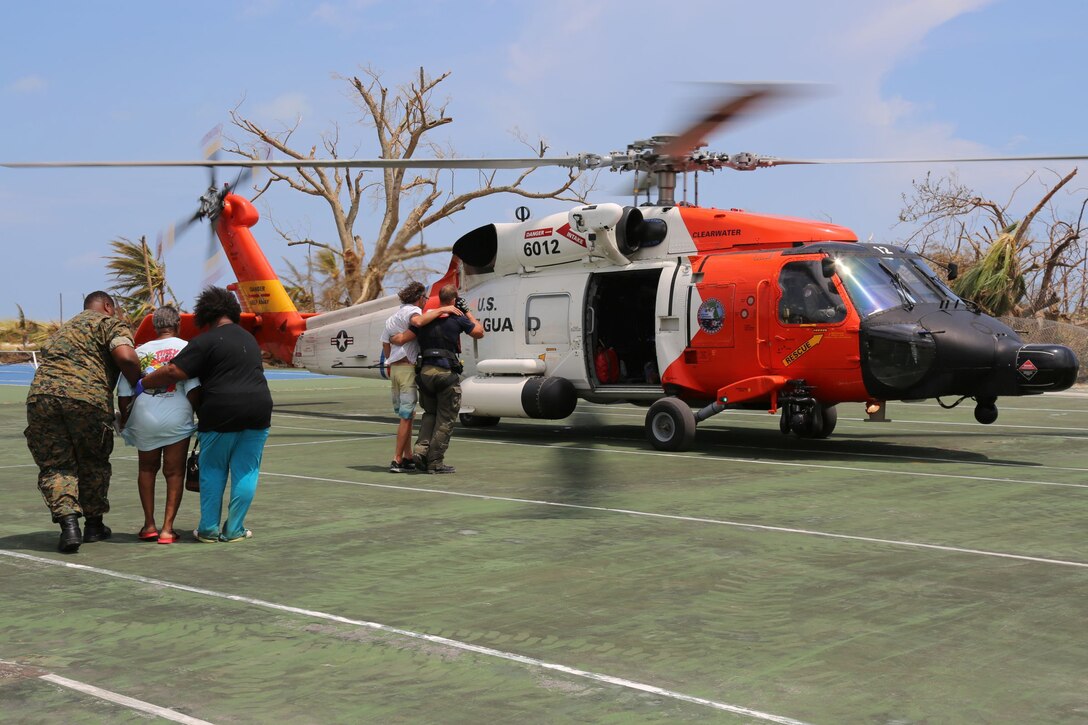 Members of the Coast Guard help victims of Hurricane Dorian to a helicopter in the Bahamas.