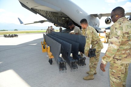 Soldiers from the 1-228th Aviation Regiment remove UH-60 Blackhawk blades from inside a C-17 Globemaster III, Aug. 26, 2019, at Soto Cano Air Base, Honduras. During a mission to support the USNS Comfort, the UH-60 crew performed a precautionary landing in an austere environment in Costa Rica. After inspecting the Blackhawk, the crew determined that aircraft was not safe to fly. Joint service members from Joint Task Force - Bravo worked together, with the assistance of a C-17 Globemaster III from U.S. Transportation Command, to return the broken helicopter back to Soto Cano. (U.S. Army photo by Martin Chahin)