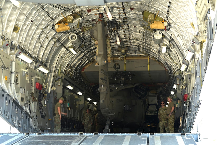Soldiers from the 1st Battalion 228th Aviation Regiment prepare to remove a broken UH-60 Blackhawk form a C-17 Globemaster III, Aug. 26, 2019, at Soto Cano Air Base, Honduras. During a mission to support the USNS Comfort, the UH-60 crew performed a precautionary landing in an austere environment in Costa Rica. After inspecting the Blackhawk, the crew determined that aircraft was not safe to fly. Joint service members from Joint Task Force - Bravo worked together, with the assistance of a C-17 Globemaster III from U.S. Transportation Command, to return the broken helicopter back to Soto Cano. (U.S. Army photo by Martin Chahin)