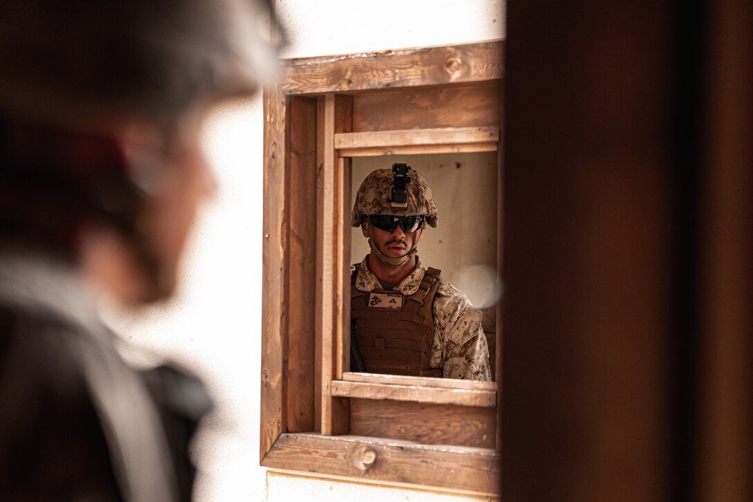 A U.S. Marine with 3rd Battalion, 7th Marine Regiment, 1st Marine Division, observes his Marines during counter improvised explosive device training at Marine Corps Air Ground Combat Center, Twentynine Palms, Calif., July 25, 2019. The training was designed to improve the confidence and proficiency in the skill sets Marines and sailors need to operate in an urban environment. (U.S. Marine Corps photo by Lance Cpl. Colton Brownlee)