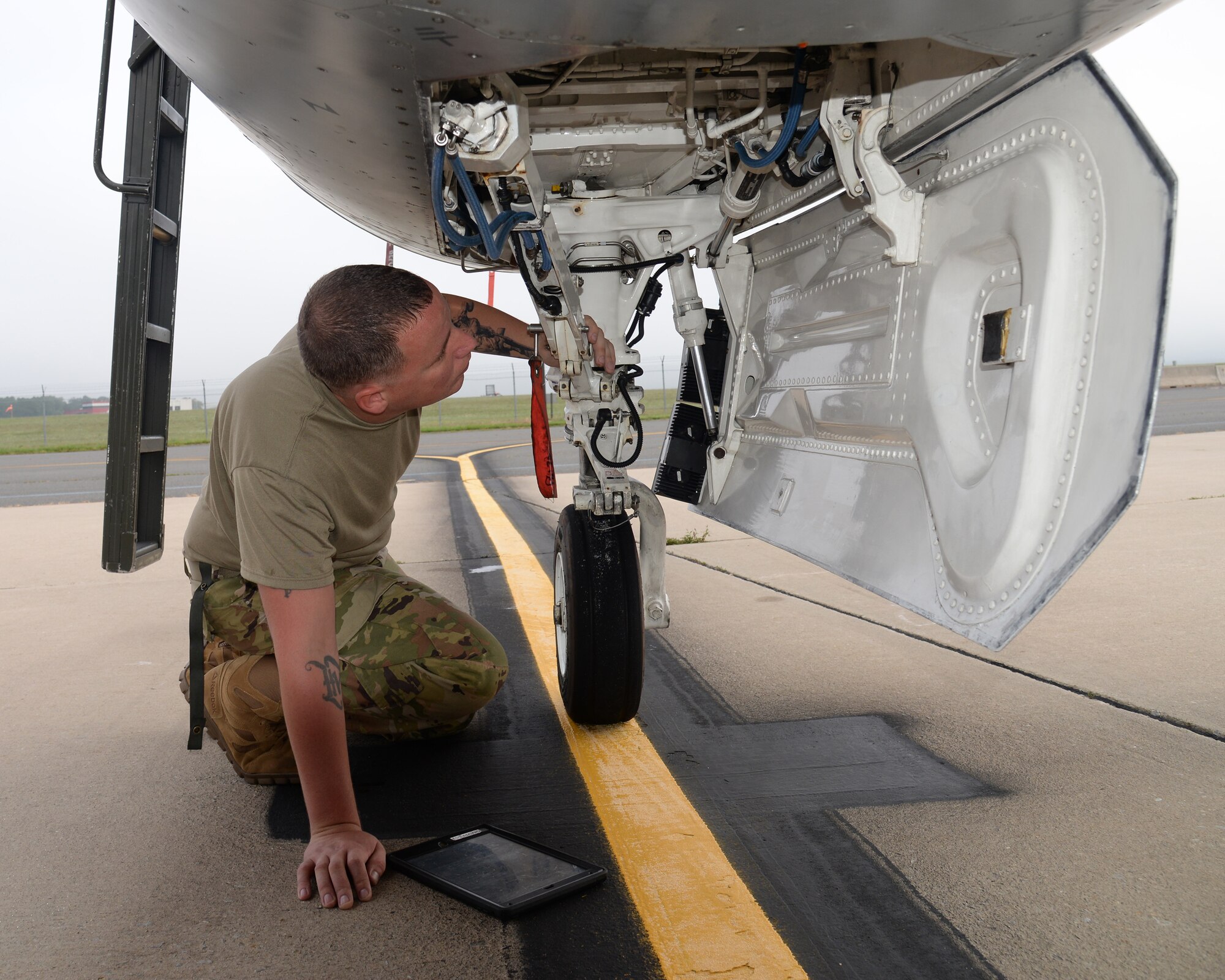 A picture of U.S. Air Force Senior Airman Andrew Heigl, crew chief with the New Jersey Air National Guard's 177th Fighter Wing, working on a 177FW F-16C Fighting Falcon.