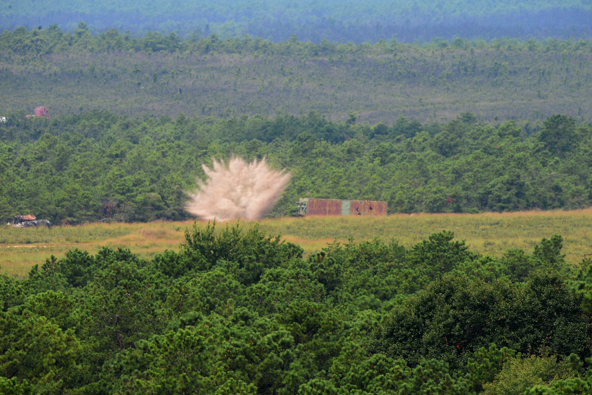 A picture of A 500 lb. inert BDU-50 practice bomb, released from a 177th Fighter Wing F-16C Fighting Falcon impacts a target at the Warren Grove Bombing Range in Ocean County, N.J.
