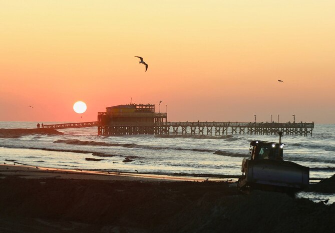 Francisco Hamm snaps a photo of a sunrise view of the continuing work on the Babe's Beach Renourishment Project on Sept. 5, in Galveston, Texas. 
(photo taken by Francisco G. Hamm, public affairs specialist, USACE Galveston District)