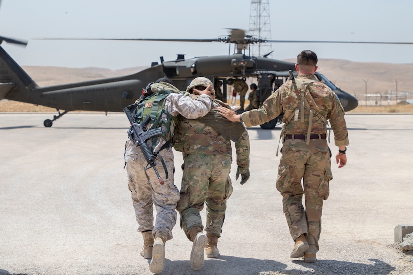 A Jordan Soldier, with 7th Mechanized Battalion, 48th Mechanized Brigade, supports a U.S. Army Soldier, with 1st Squadron, 102nd Cavalry Regiment, 44th Infantry Brigade Combat Team of the 42nd Infantry Division, New Jersey National Guard, and walks him toward a UH-60 Black Hawk during medical evacuation training, part of the Jordan Operational Engagement Program at Joint Training Center-Jordan August 27, 2019. The Army is optimizing for interoperability with all our allies and partners to strengthen alliances and deliver more effective coalition operations.