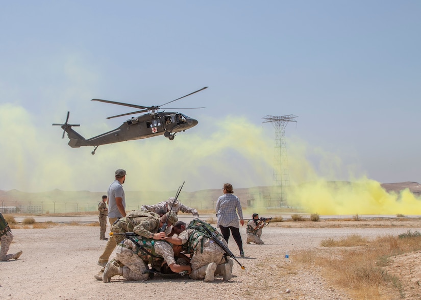 Jordan Soldiers, with 7th Mechanized Battalion, 48th Mechanized Brigade, cover to protect a notionally injured U.S. Army Soldier, with 1st Squadron, 102nd Cavalry Regiment, 44th Infantry Brigade Combat Team of the 42nd Infantry Division, New Jersey National Guard, as a UH-60 Black Hawk lands during medical evacuation training, part of the Jordan Operational Engagement Program at Joint Training Center-Jordan August 27, 2019. The Army is optimizing for interoperability with all our allies and partners to strengthen alliances and deliver more effective coalition operations.