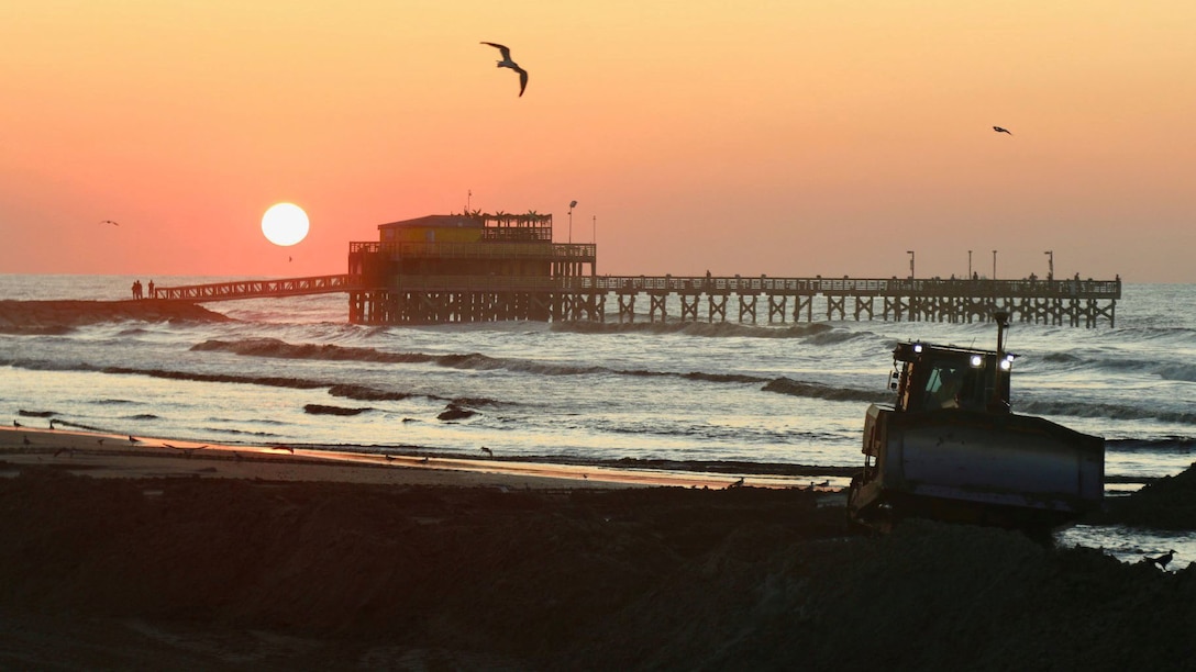 Francisco Hamm snaps a photo of a sunrise view of the continuing work on the Babe's Beach Renourishment Project on Sept. 5, in Galveston, Texas. (photo taken by Francisco G. Hamm, public affairs specialist, USACE Galveston District)