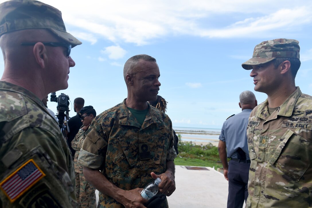 Maj. Christopher J. Ahlemeyer, of the Rhode Island National Guard (right), speaks with Commodore Tellis A. Bethel, commander, Royal Bahamas Defence Force (center), and Col. Andrew J. Chevalier, of the Rhode Island National Guard, following a joint forces assault exercise Tradewinds 2018. Tradewinds is a U.S. Southern Command sponsored exercise that provides participating Caribbean nations the opportunity to improve security and disaster response capabilities.