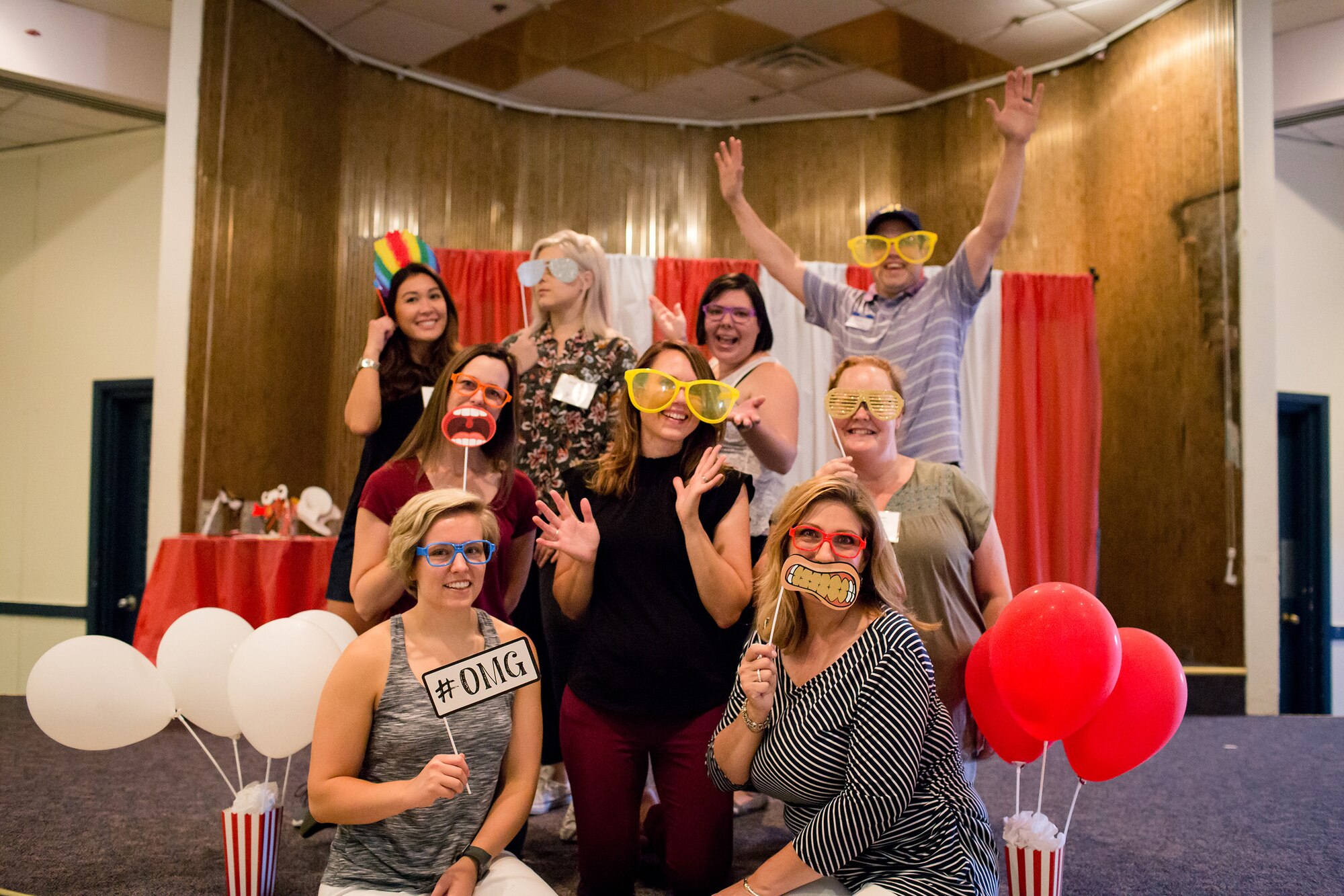 Members of the Kirtland Spouses Club pose in the photo booth during a membership carnival kick off event at Kirtland Air Force Base, N.M.