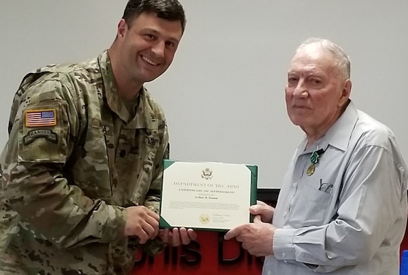 Deputy District Commander Lt. Col. Nathan Molica presents Art Hamm with his Certificate of Retirement.