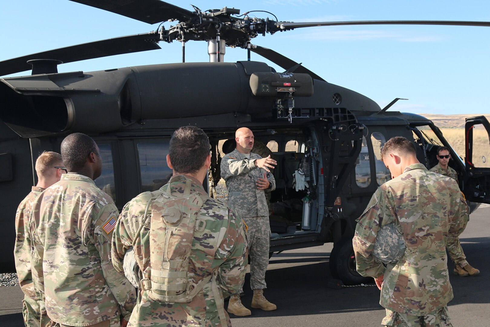 Soldiers with the 16th Combat Aviation Brigade provide medevac training to Illinois Army National Guard Soldiers from the 1844th Transportation Company as part of Rising Thunder 2019 at Yakima Training Center in Yakima, Washington, August 30, 2019.