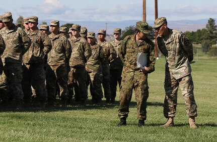 Translators from the Illinois Army National Guard and the Japan Ground Self-Defense Force discuss the Rising Thunder 2019 opening ceremony at Yakima Training Center, Washington, Aug. 30, 2019.