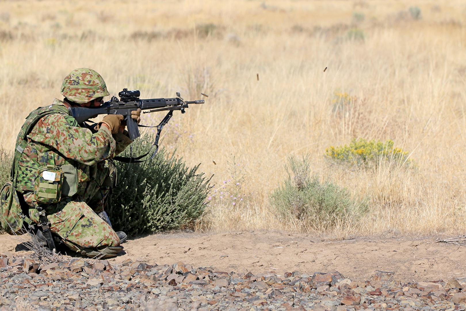 A soldier from the Japan Ground Self-Defense Force opens fire on his target in a live fire exercise during Rising Thunder, Sep. 1, at the Yakima Training Center in Yakima, Washington.
