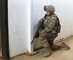 A Soldier from the 2nd Battalion, 130th Infantry Regiment, 33rd Infantry Brigade Combat Team, Illinois Army National Guard, posts guard at the entrance of a training building while the rest of his team completes room clearances during Rising Thunder 19 at the Yakima Training Center in Yakima, Washington, Sept. 1, 2019.