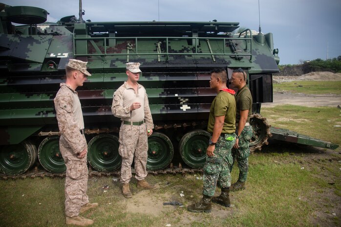 U.S. Marine Corps Sgt. Thomas Pelham and Sgt. Timothy Hoff inspect the tracks of an assault amphibious vehicle with Philippine Marines during an AAV subject matter expert exchange in Subic Bay, Philippines, Aug. 30, 2019. The U.S. Marine Corps has partnered with the Philippine Marine Corps for the last eight years to develop skill sets and policies to enable the Philippine Navy and Marine Corps to conduct amphibious operations. This SMEE was a milestone in these efforts, marking the first time that Philippine forces launched their AAVs from a Philippine Navy amphibious ship and transited from ship to shore. Pelham and Hoff are a mechanic and section leader, respectively, with AAV Company, 4th Marine Regiment, 3rd Marine Division and are natives of Reno, Nev., and Waldorf, Md., respectively. (U.S. Marine Corps photos by Lance Cpl. Jacob Hancock)