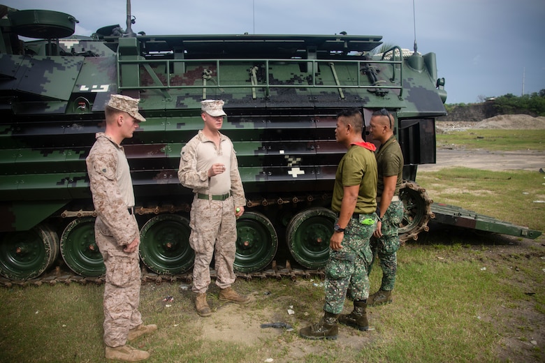 U.S. Marine Corps Sgt. Thomas Pelham and Sgt. Timothy Hoff inspect the tracks of an assault amphibious vehicle with Philippine Marines during an AAV subject matter expert exchange in Subic Bay, Philippines, Aug. 30, 2019. The U.S. Marine Corps has partnered with the Philippine Marine Corps for the last eight years to develop skill sets and policies to enable the Philippine Navy and Marine Corps to conduct amphibious operations. This SMEE was a milestone in these efforts, marking the first time that Philippine forces launched their AAVs from a Philippine Navy amphibious ship and transited from ship to shore. Pelham and Hoff are a mechanic and section leader, respectively, with AAV Company, 4th Marine Regiment, 3rd Marine Division and are natives of Reno, Nev., and Waldorf, Md., respectively. (U.S. Marine Corps photos by Lance Cpl. Jacob Hancock)