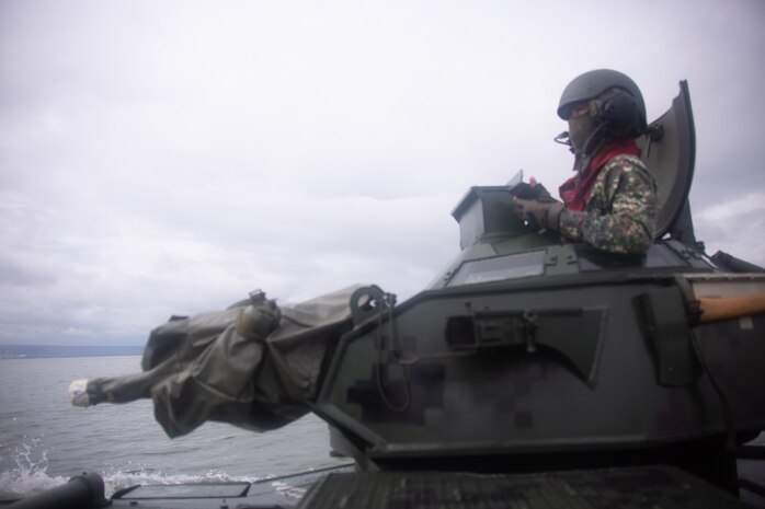 Philippine Marine Corps 1st Lt. Marever Taghap sits in the turret of an assault amphibious vehicle that is being driven by U.S. Marines during an AAV subject matter expert exchange in Subic Bay, Philippines, Sept. 1, 2019. The U.S. Marine Corps has partnered with the Philippine Marine Corps for the last eight years to develop skill sets and policies to enable the Philippine Navy and Marine Corps to conduct amphibious operations. This SMEE was a milestone in these efforts, marking the first time that Philippine forces launched their AAVs from a Philippine Navy amphibious ship and transited from ship to shore. The U.S. Marines are from AAV Company, 4th Marine Regiment, 3rd Marine Division. (U.S. Marine Corps photos by Lance Cpl. Jacob Hancock)