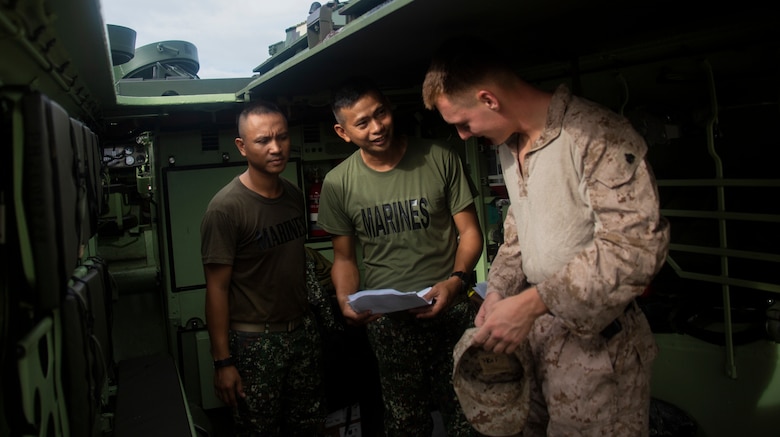 U.S. Marine Corps Sgt. Timothy Hoff discusses an assault amphibious vehicle operation plan with Philippine Marines in preparation for an AAV launch during an AAV subject matter expert exchange in Subic Bay, Philippines, Aug 30. 2019. The U.S. Marine Corps has worked with the Philippine Marine Corps for the last eight years to develop concepts and doctrine that will enable the Philippine Navy-Marine team to conduct amphibious operations. This event is a milestone in these efforts and the start of a greater opportunity for the U.S. and Philippine forces to increase interoperability and share an amphibious capability in the Indo-Pacific region. Hoff is a section leader with AAV Company, 4th Marine Regiment, 3rd Marine Division, and is a native of Waldorf, Md. (U.S. Marine Corps photo by Lance Cpl. Jacob Hancock)