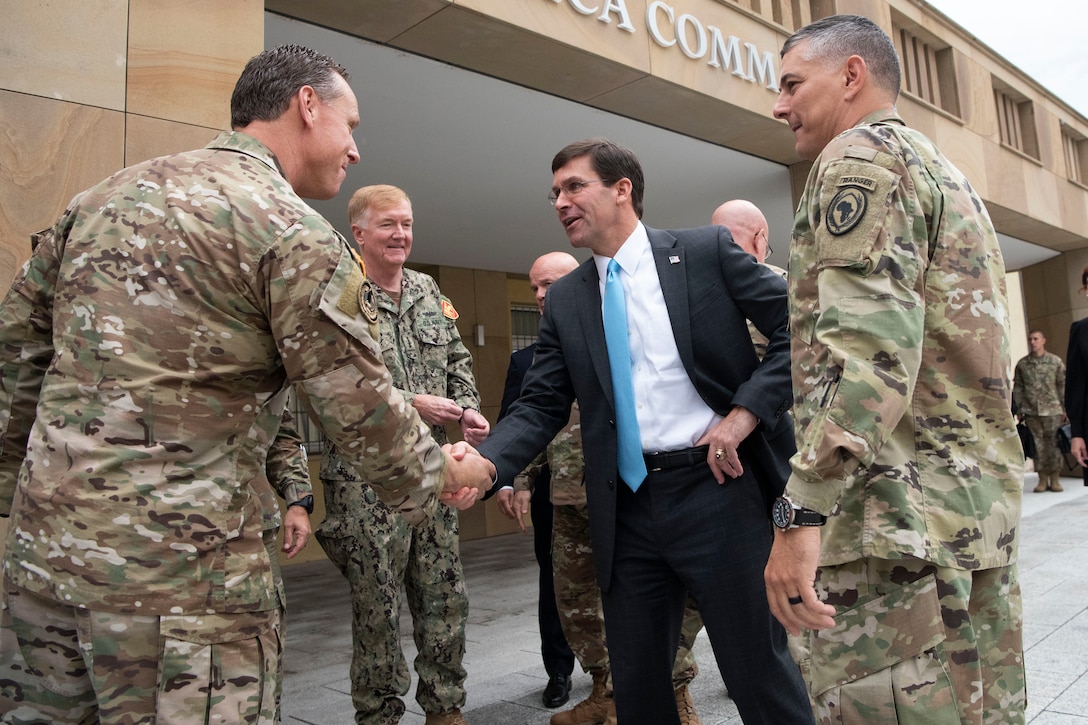 Defense Secretary Dr. Mark T. Esper greets a group of military officers.