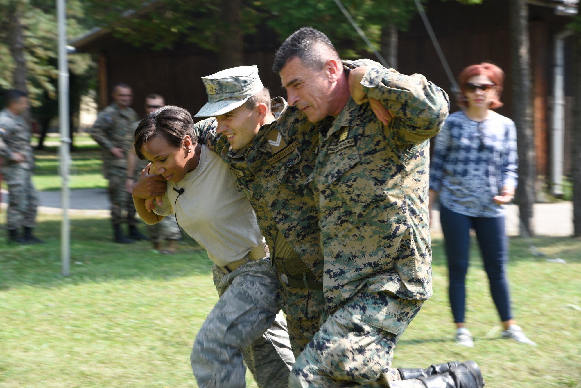 Tech. Sgt. Patricia Medina, medical administrator, 175th Medical Group, Maryland Air National Guard performs a SEAL Team Three carry with members of the Armed Forces of Bosnia-Herzegovina, during a medical training exercise August 26, 2019, Banja Luka, Bosnia. Throughout the training, soldiers of the Armed Forces of Bosnia-Herzegovina received classroom instruction in addition to hands-on tactical combat casualty care application training. (U.S. Air National Guard photo by Staff Sgt. Enjoli Saunders)