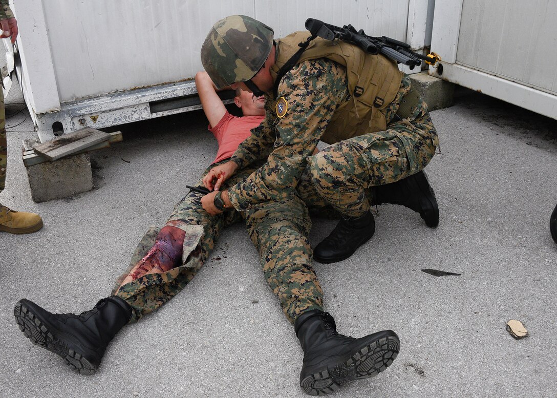 A member of the Armed Forces of Bosnia-Herzegovina applies a tourniquet to an injury during the final training exercise that simulated a real-world combat situation, August 29, 2019, Banja Luka, Bosnia. The purpose of the training was to ensure members of the Armed Forces of Bosnia-Herzegovina are able to effectively respond to medical emergencies or casualties in combat situations. (U.S. Air National Guard photo by Staff Sgt. Enjoli Saunders)