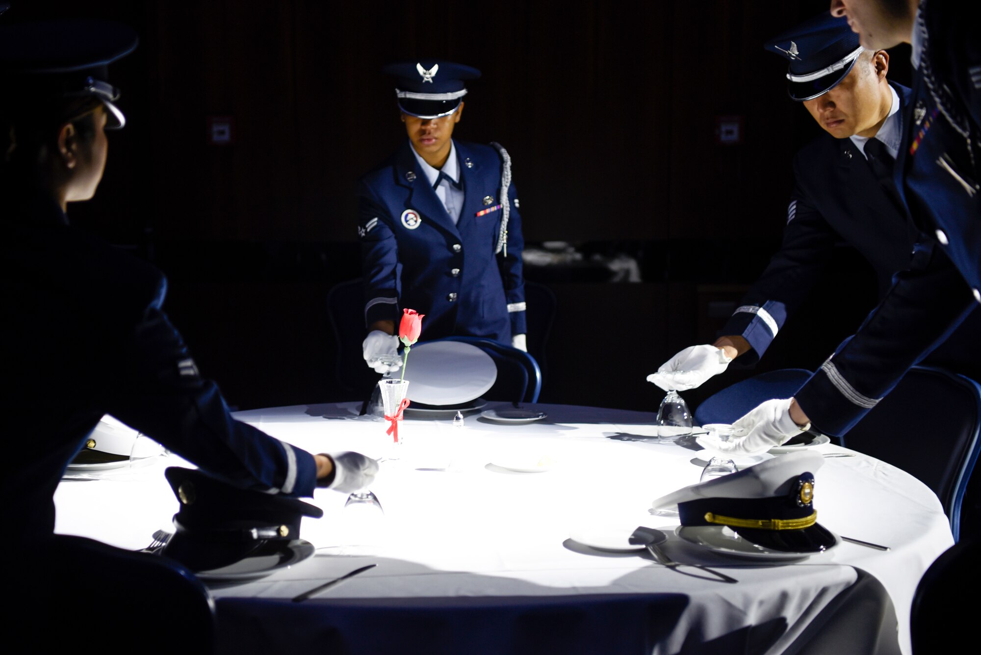 U.S. Air Force Airmen from the 52nd Fighter Wing Base Honor Guard perform a prisoner-of-war and missing-in-action presentation during the annual POW/MIA Recognition Ceremony at Spangdahlem Air Base, Germany, Sept. 6, 2019. The table was set for six to represent fallen or missing service members from the five U.S. military branches and civilians. (U.S. Air Force photo by Airman 1st Class Valerie Seelye)