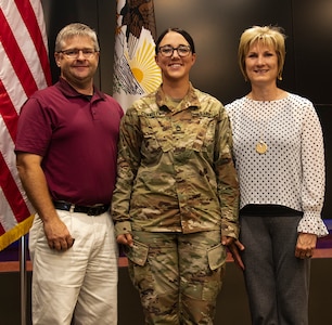 Sgt. 1st Class Erin Connelly, joined by sister, Candy Jansen, and brother-in-law, Larry Jansen, was promoted to her current rank Sept. 4 at the Illinois Military Academy, Camp Lincoln, Springfield, Illinois.