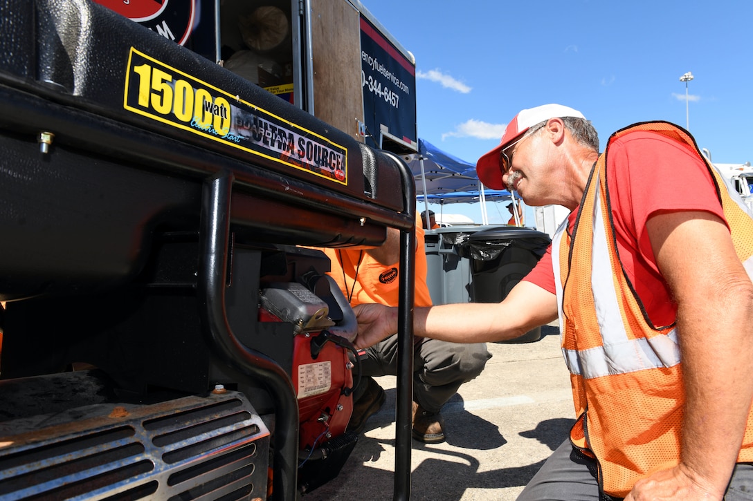 Steve Isaacs, a driver for Foster Fuels, performs maintenance on a power generator staged at Robins Air Force Base, Georgia, Sept. 3, 2019, in support of emergency response to Hurricane Dorian.