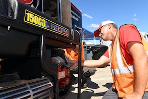 Steve Isaacs, a driver for Foster Fuels, performs maintenance on a power generator staged at Robins Air Force Base, Georgia, Sept. 3, 2019, in support of emergency response to Hurricane Dorian.