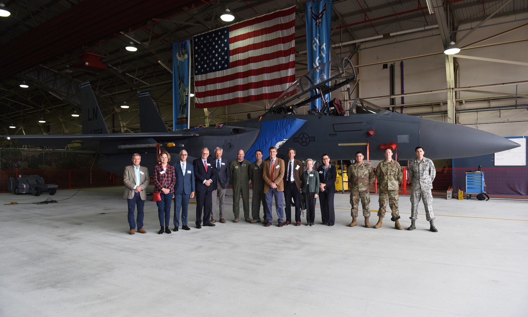 Distinguished visitors gather for a group photo in front of an F-15E Strike Eagle at Royal Air Force Lakenheath, England, Sept. 6, 2019. High Sheriffs play an increasingly active and supportive role within their counties both in relation to the police and emergency services and in lending encouragement to public sector agencies. (U.S. Air Force photo by Airman 1st Class Madeline Herzog)