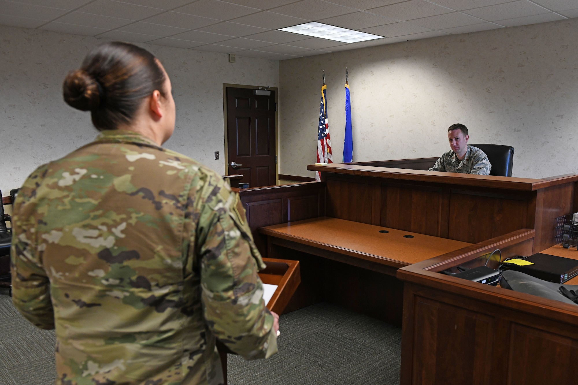a women stands in legal room with a man