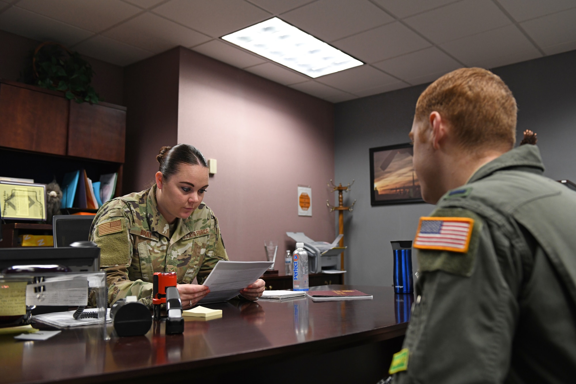 a women helps a man in an office