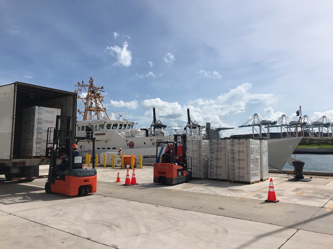 Crews load cutter with hurricane relief supplies