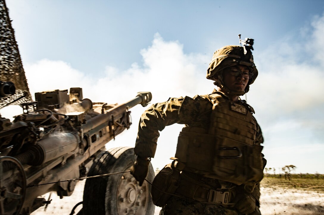 Marine fires a howitzer.