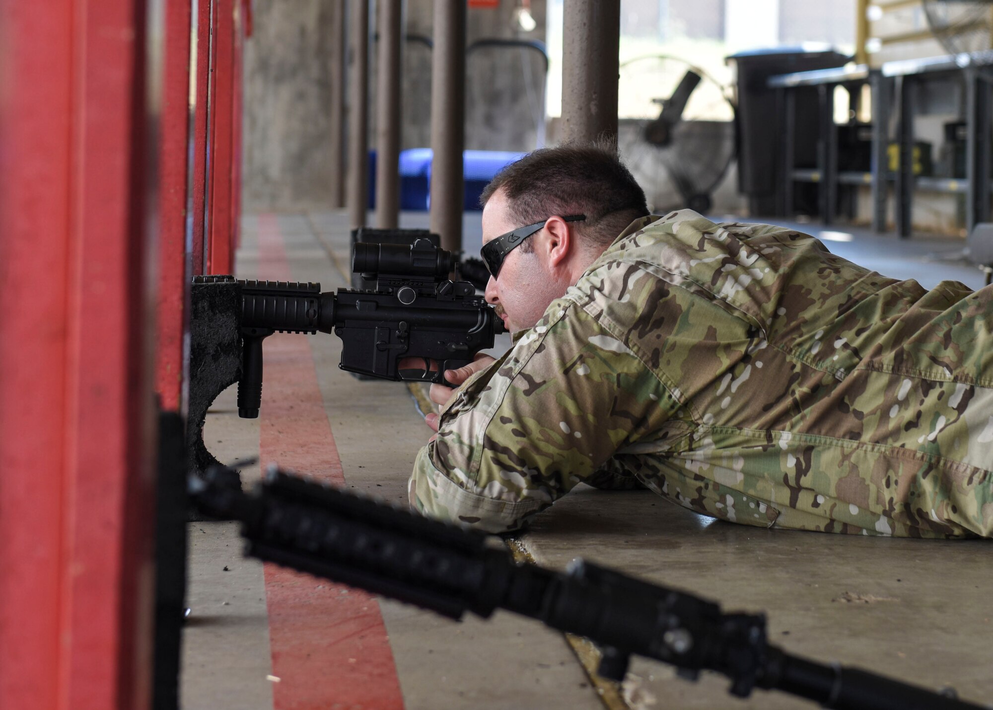 Staff Sgt. Mitchell Coffey, 377th Security Forces Squadron combat arms instructor, demonstrates the prone position for students at Sheppard Air Force Base, Sept. 6, 2019. These instructors ensure that Airmen remain qualified in weapon safety and use in order to deploy at a moment's notice. (U.S. Air Force photo by Senior Airman Ilyana A. Escalona)