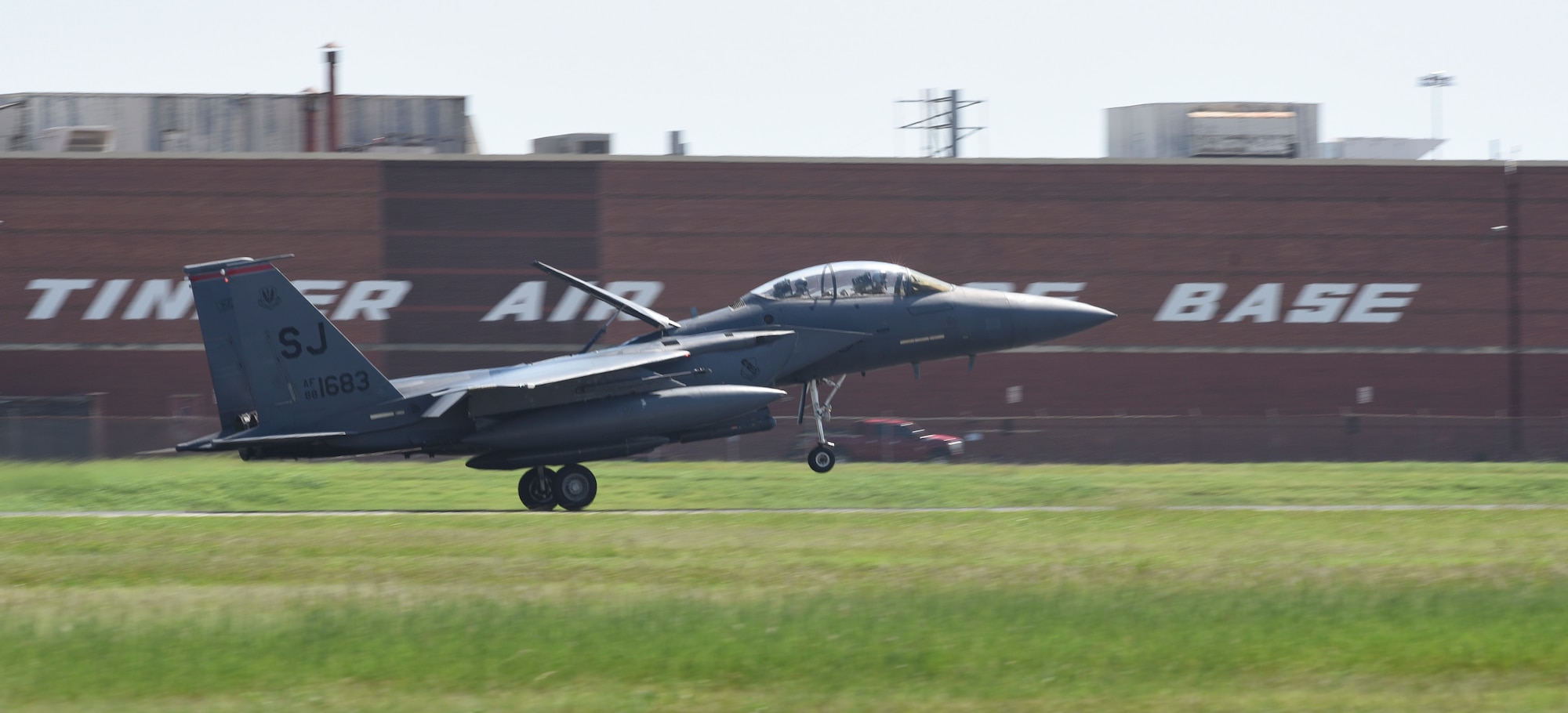 An F-15E Strike Eagle aircraft from the 4th Fighter Wing, Seymour-Johnson Air Force Base, North Carolina, lands with its airbrake deployed at Tinker AFB, Oklahoma as part of a mass-relocation of vulnerable aircraft to escape Hurricane Dorian's path Sept. 4, 2019, Tinker AFB, Oklahoma. Team Tinker executed an existing agreement with Seymour-Johnson AFB, North Carolina and Warner-Robins AFB, Georgia to host fighters, tankers and reconnaissance aircraft far away from the devastating hurricane currently impacting the East Coast of the United States. (U.S. Air Force photo/Greg L. Davis)