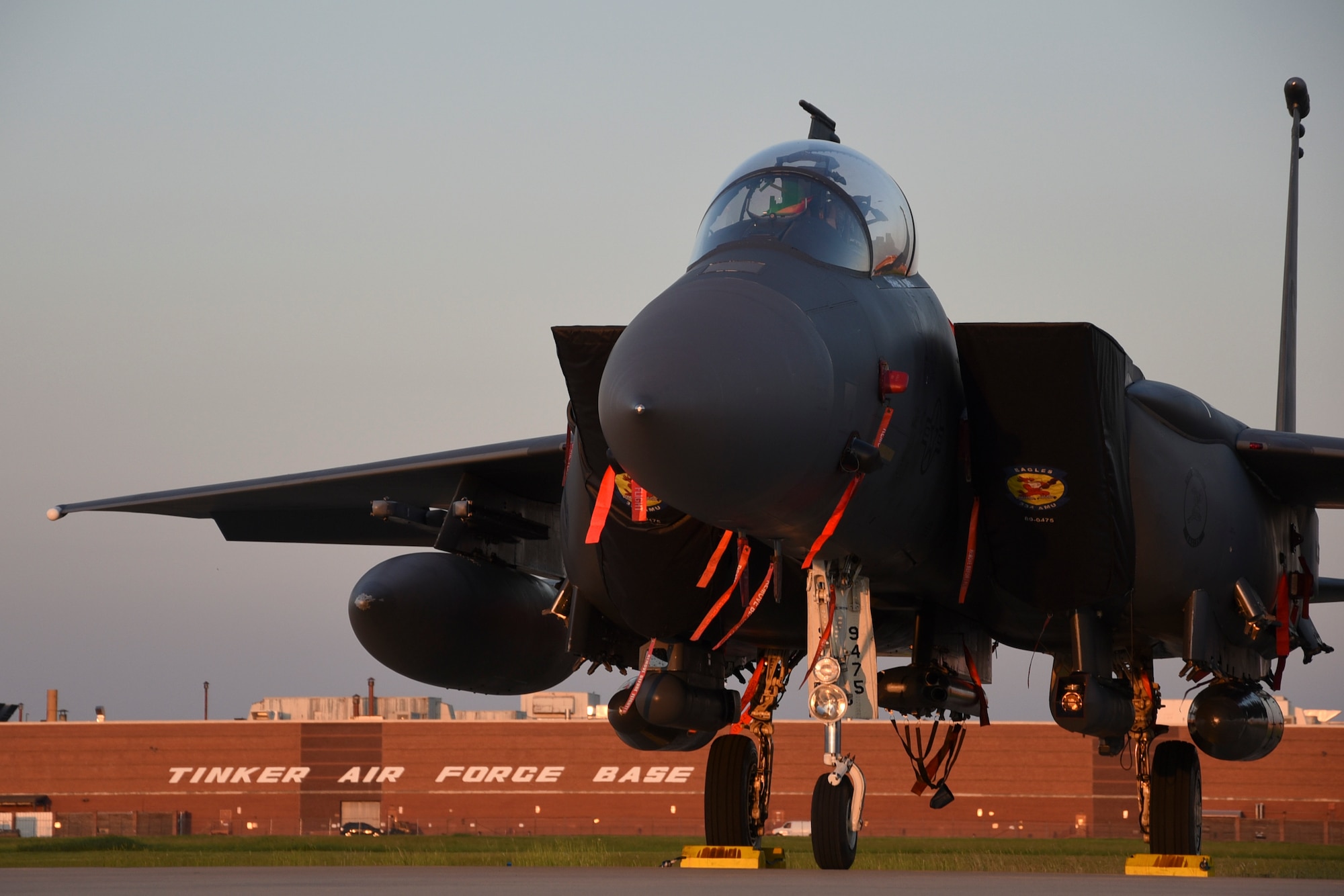 An F-15E Strike Eagle basks in the late evening light after escaping Hurricane Dorian's path and relocating to Tinker Air Force Base, Oklahoma, Sept. 4, 2019. The F-15E is assigned to the 4th Fighter Wing, Seymour-Johnson AFB, North Carolina, as part of Air Combat Command. Team Tinker executed an existing agreement with Seymour-Johnson AFB, North Carolina and Warner-Robins AFB, Georgia to host fighters, tankers and reconnaissance aircraft far away from the devastating hurricane impacting the East Coast of the United States. (U.S. Air Force photo/Greg L. Davis)
