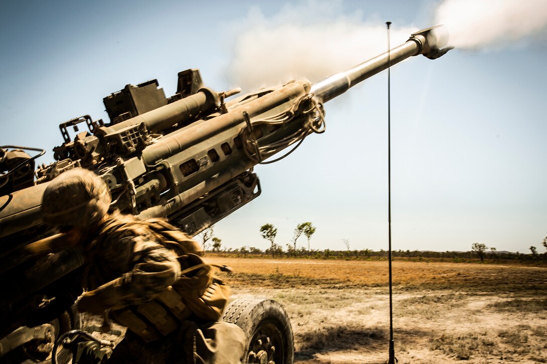 Marines fire a howitzer.