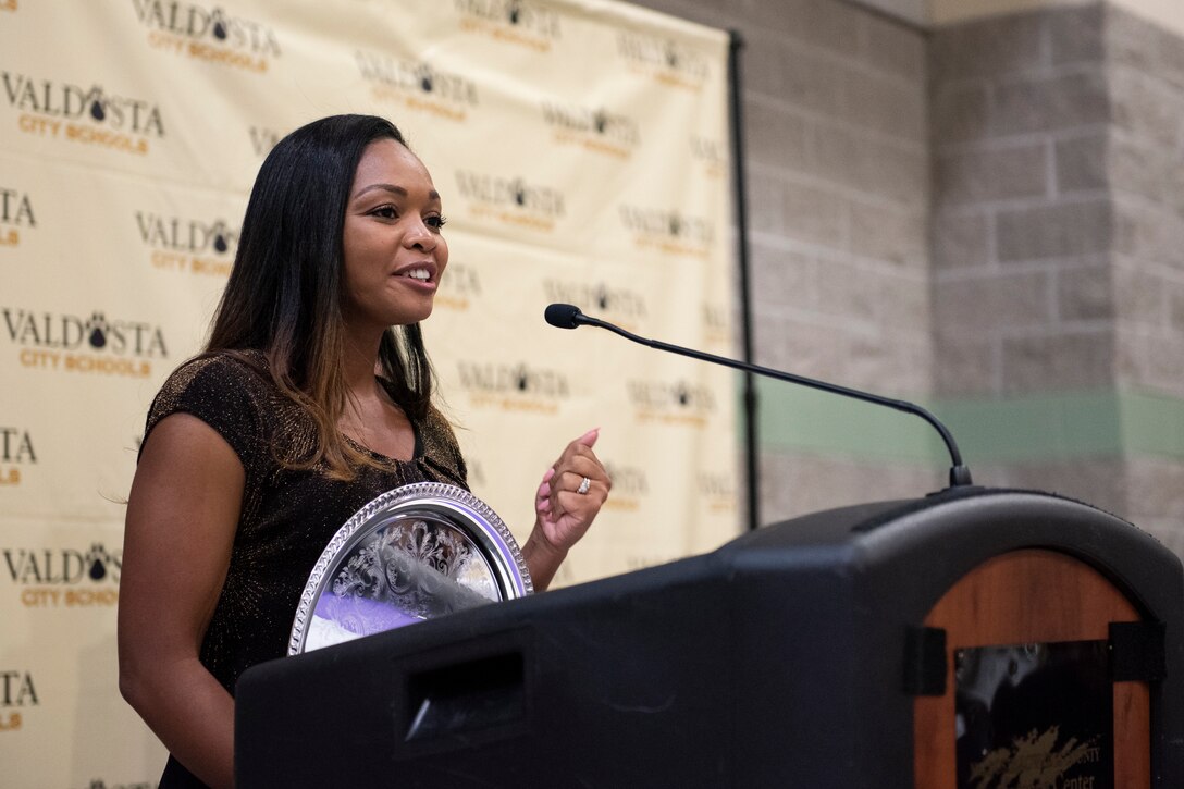 Melvina Murray, Valdosta City Schools (VCS) 2019 Teacher of the Year Award recipient and Team Moody spouse, speaks after receiving her award during the VCS 2019 Teacher of the Year Banquet Sept. 5, 2019, at the Rainwater Conference Center, Valdosta, Ga. Murray received the award for being the system’s educator who not only embodied her school’s core expectations of integrity first, respect for yourself and others, and excellence in all we do, but also consistently placed her service before herself.  This year the VCS system named Murray as one of two recipients to recognize her hard work and dedication before the Murray family relocates to California mid-September. (U.S. Air Force photo by 2nd Lt. Kaylin P. Hankerson)