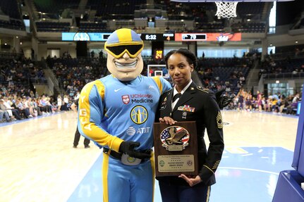 Sky Guy, left, the Women’s National Basketball Association’s Chicago Sky team mascot, and U.S. Army Reserve Master Sgt. Ebony Evans pause for a photo after she receives an honor for her service during the Chicago Sky’s final home game, of the regular season, at the Wintrust Arena in Chicago, Illinois, September 1, 2019.