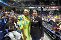 U.S. Army Reserve Master Sgt. Ebony Evans, right, pauses for a photo with a game spectator after she received an honor for her service during the Chicago Sky’s final home game, of the regular season, at the Wintrust Arena in Chicago, Illinois, September 1, 2019.